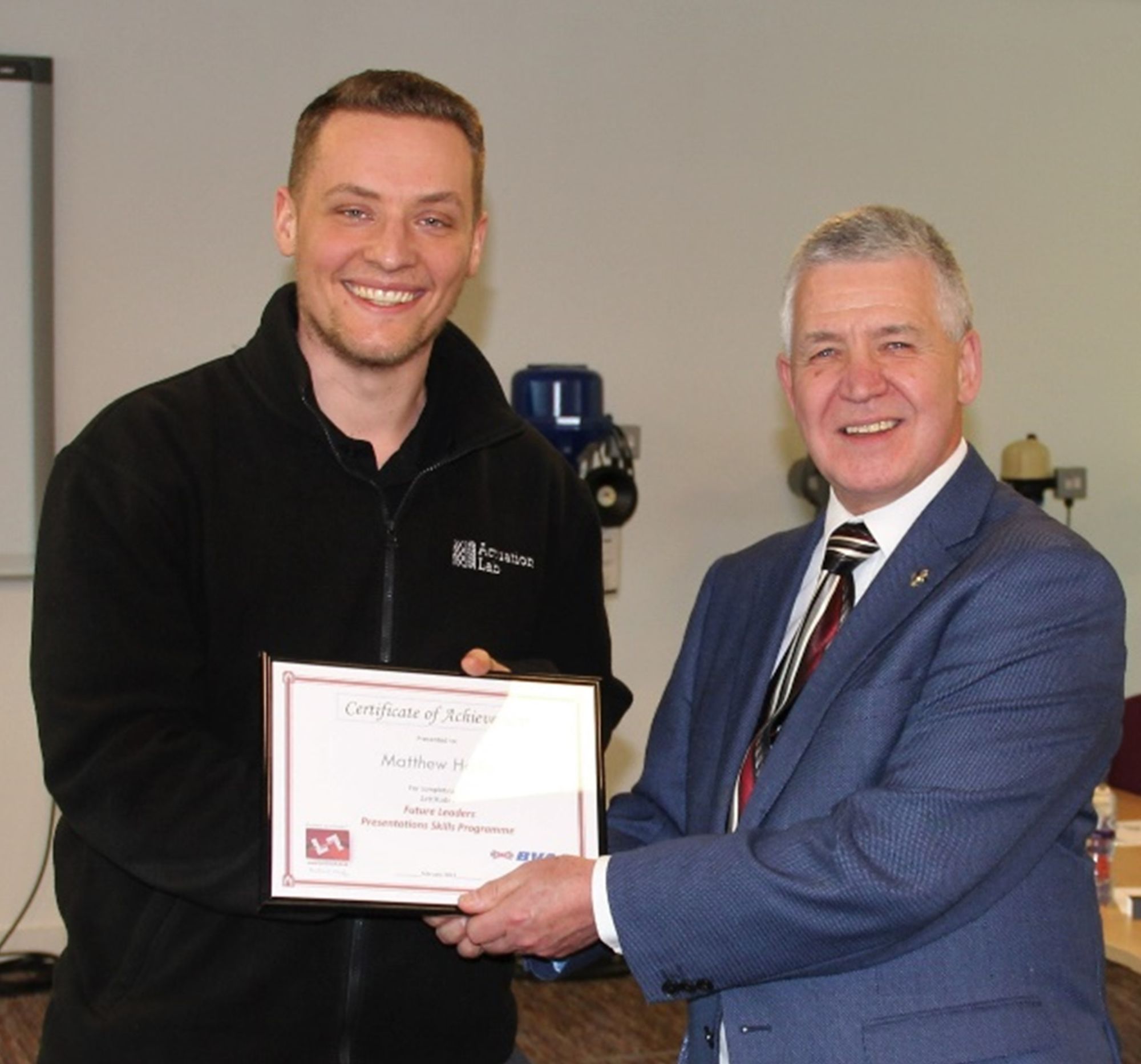 R&D Engineer Matthew Hollis receiving a Certificate of Achievement from Dr Martin Haigh