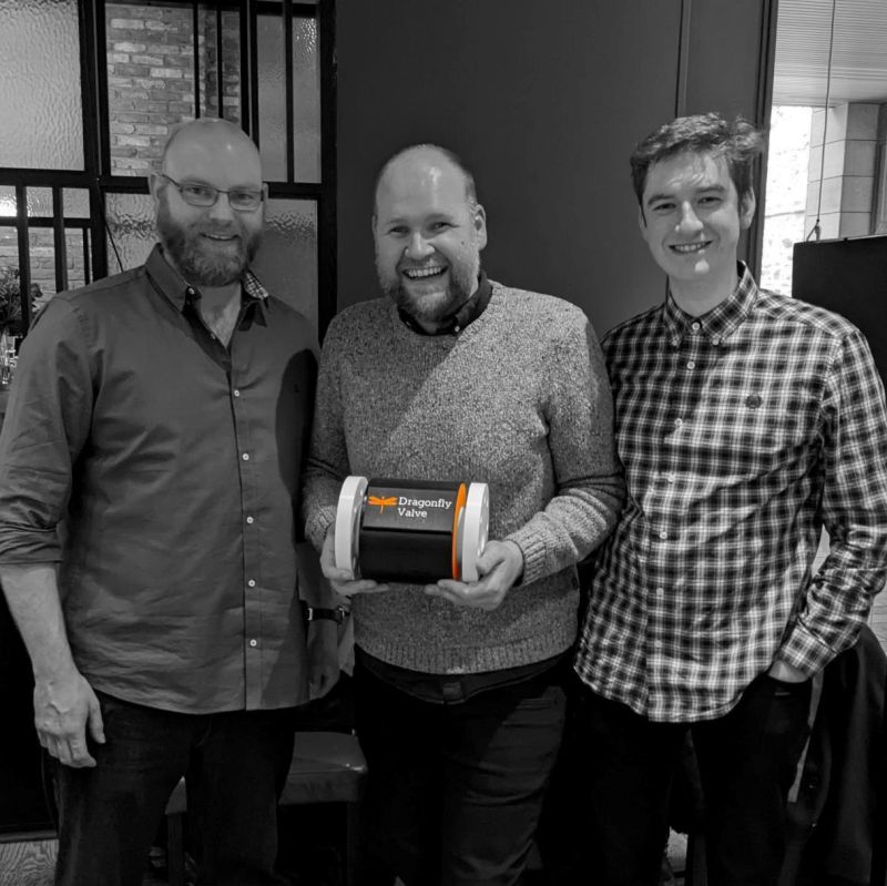 Picture of our CTO Michael Dicker holding a Dragonfly Valve, with Rory Ingram and Daniel McDaid