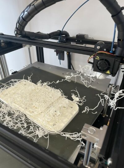 A 3D print gone wrong, resulting in a stringy mess of white filament, which is reminiscent of noodles!